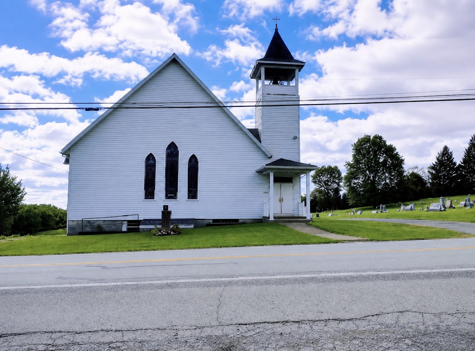 White church building of Middletown Fellowship Church under a blue sky